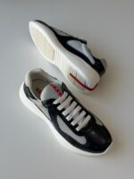 Prada Sneakers in white leather with bold red accent stripe and rubber logo patch