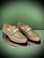 Elegant Hermès Loafers in black leather with signature metallic H buckle for UAE market