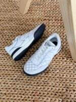 Chanel Shiny Embroidered Leather Sneakers featuring metallic finish, floral embroidery, and CC logo on the tongue