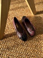 Chanel Leather Ballet Flats in black lambskin with iconic contrast cap toe and interlocking CC logo detail