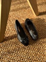 Chanel Leather Ballet Flats in black lambskin with iconic contrast cap toe and interlocking CC logo detail