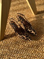 Dolce & Gabbana Kim Leopard Print Slingback Heels in polished calfskin with pointed toe and logo plaque on the stiletto heel