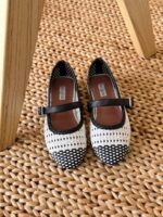 Alaïa Mary Jane Flats with signature woven pattern, delicate ankle strap, and pointed toe