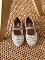 Alaïa Mary Jane Flats with signature woven pattern, delicate ankle strap, and pointed toe