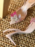 Iconic serpent-wrap strap with shimmering crystals.