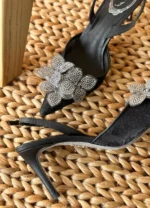 Iconic serpent-wrap strap with shimmering crystals.