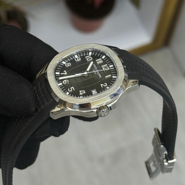 Patek Philippe Aquanaut watch with black embossed dial